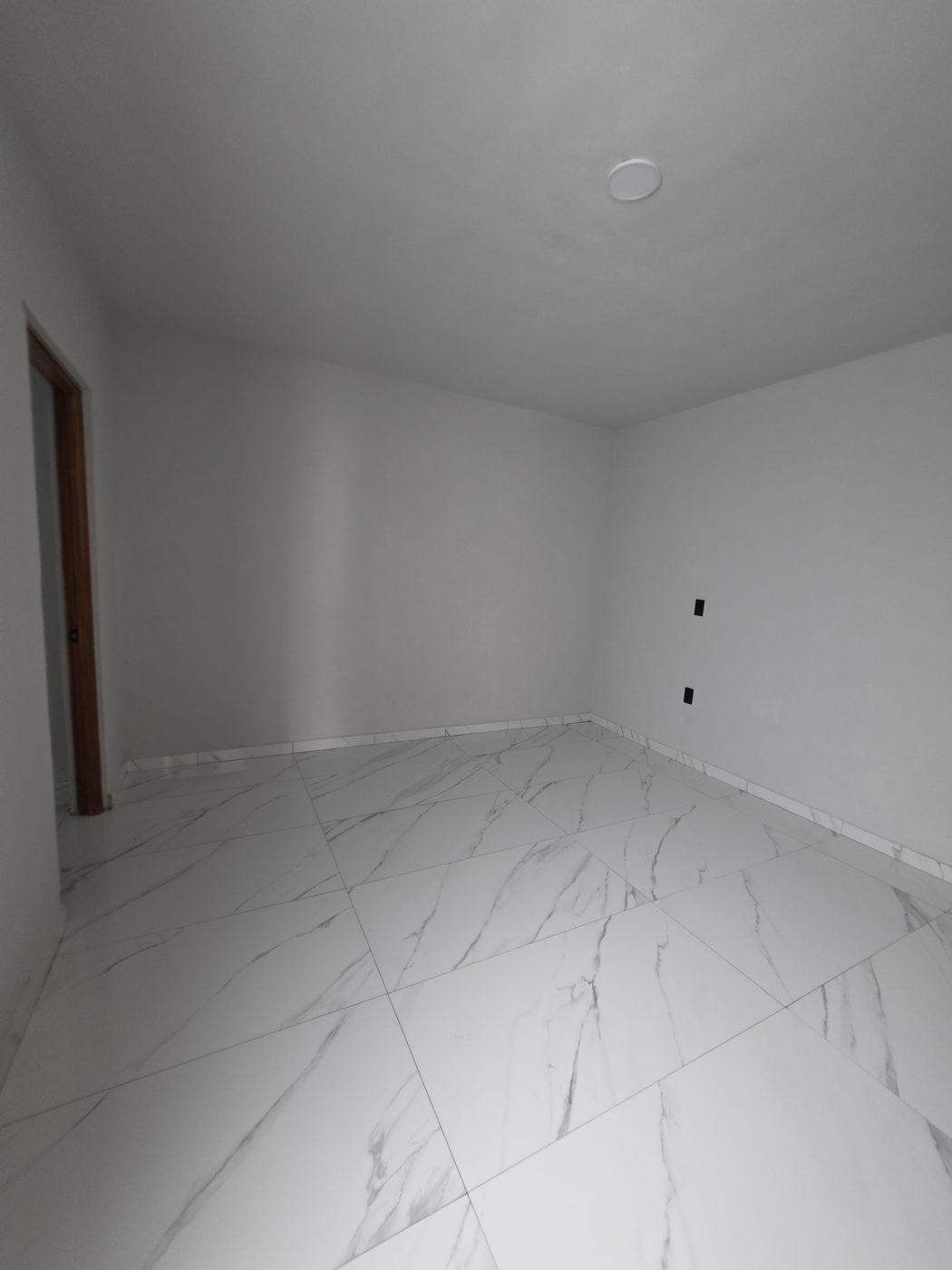 Recámara terminada con piso porcelánico tipo mármol