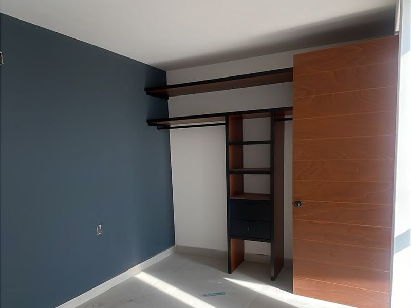 Recámara con muro azul y clóset a la medida